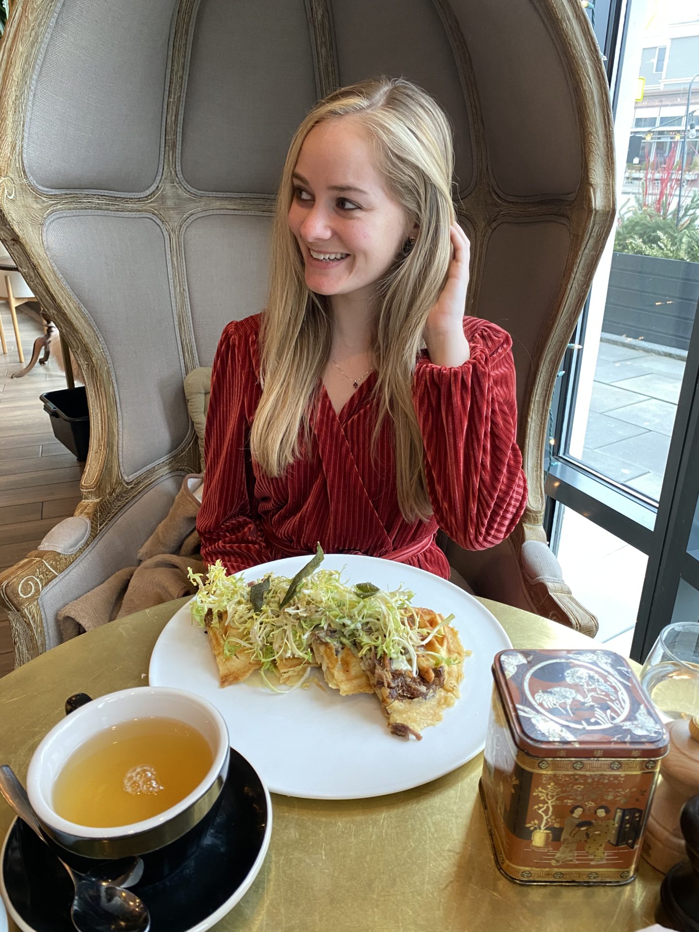 Influencer sitting in tall chair for brunch at Colette Wine Bistro